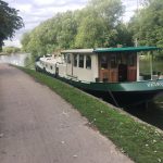 Green barge named patricia with a union jack flag