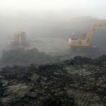 Two diggers in the fog